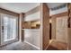 Open living area with carpet, pass-through window to kitchen and view to front door at 808 Myrtle Ct. # 808, North Myrtle Beach, SC 29582