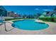 Community pool with a paver deck, surrounded by well-maintained landscaping and colorful beach houses at 808 Myrtle Ct. # 808, North Myrtle Beach, SC 29582