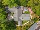 Aerial view of a charming home with a well-manicured lawn, patio, and mature trees at 81 Prestwick Dr., Pawleys Island, SC 29585