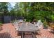 Beautiful backyard patio with a table, seating arrangements, and lush landscaping at 81 Prestwick Dr., Pawleys Island, SC 29585