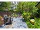 Beautiful backyard patio with outdoor seating, lush greenery, and stone features at 81 Prestwick Dr., Pawleys Island, SC 29585