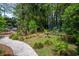 Idyllic backyard oasis featuring lush landscaping, inviting patio, and serene bird bath at 81 Prestwick Dr., Pawleys Island, SC 29585