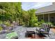 Serene backyard patio with outdoor seating, mature landscaping, and charming accents at 81 Prestwick Dr., Pawleys Island, SC 29585