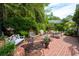 Charming backyard patio with various seating arrangements, flowers, and mature trees at 81 Prestwick Dr., Pawleys Island, SC 29585