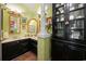 Powder room features stylish vanity, decorative mirrors, and decorative black display cabinet at 81 Prestwick Dr., Pawleys Island, SC 29585