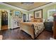 Stylish bedroom featuring dark hardwood floors, floral bedding, a decorative dresser and detailed trim at 81 Prestwick Dr., Pawleys Island, SC 29585