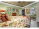 Bright bedroom with hardwood floors, patio access, and floral bedding complemented by artwork and natural light at 81 Prestwick Dr., Pawleys Island, SC 29585
