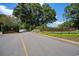 Grand community entrance featuring manicured hedges, colorful flower beds, and well-maintained road at 81 Prestwick Dr., Pawleys Island, SC 29585