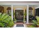 Charming front entrance featuring double doors, brick patio, and decorative columns with flourishing plants at 81 Prestwick Dr., Pawleys Island, SC 29585