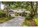Stunning home featuring lush landscaping, a circular driveway, and a charming yellow exterior at 81 Prestwick Dr., Pawleys Island, SC 29585