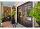 Inviting front porch boasts brick flooring, double doors, and a stylish decor with potted plants and furniture at 81 Prestwick Dr., Pawleys Island, SC 29585