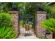Elegant wrought iron gate framed by brick pillars, enhancing the landscaped yard at 81 Prestwick Dr., Pawleys Island, SC 29585