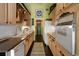 Functional kitchen with light wood cabinets, granite countertops, and modern appliances and fixtures at 81 Prestwick Dr., Pawleys Island, SC 29585