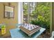 Cozy screened porch with checkerboard game, inviting natural light and outdoor views at 81 Prestwick Dr., Pawleys Island, SC 29585