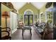 Relaxing sun room features dark hardwood floors, a vaulted ceiling, and abundant natural light and decor at 81 Prestwick Dr., Pawleys Island, SC 29585