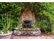 A water fountain, lush greenery, and brick patio create a peaceful backyard scene at 81 Prestwick Dr., Pawleys Island, SC 29585