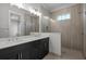 Luxurious primary bathroom with double vanity, and a glass-enclosed shower featuring stylish tile work at 8148 Living Tide Dr., Myrtle Beach, SC 29572