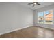 Bright bedroom with hardwood floors, ceiling fan, and double windows offering a sun-filled interior at 8148 Living Tide Dr., Myrtle Beach, SC 29572