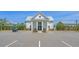 Exterior of a community building with white siding, columns, and well-maintained landscaping at 8148 Living Tide Dr., Myrtle Beach, SC 29572