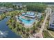 Aerial view of a community pool area with palm trees, lounge chairs, and a picturesque gazebo at 8148 Living Tide Dr., Myrtle Beach, SC 29572