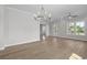 Bright dining area boasts beautiful hardwood floors and contemporary chandelier lighting at 8148 Living Tide Dr., Myrtle Beach, SC 29572