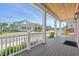 Inviting covered front porch with wood ceiling and detailed trim overlooks a landscaped street view at 8148 Living Tide Dr., Myrtle Beach, SC 29572
