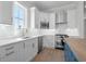 Beautiful kitchen with white cabinets, quartz countertops, stainless appliances, and tile backsplash at 8148 Living Tide Dr., Myrtle Beach, SC 29572