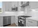 Close-up of a chef's kitchen featuring stainless steel appliances and bright white cabinetry at 8148 Living Tide Dr., Myrtle Beach, SC 29572