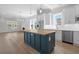 Open kitchen with a blue island, stainless steel appliances, and seamless flow to the living area at 8148 Living Tide Dr., Myrtle Beach, SC 29572