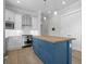 Modern kitchen with white cabinets, stainless appliances, and blue island with butcher block top at 8148 Living Tide Dr., Myrtle Beach, SC 29572