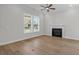 Bright living room features hardwood floors, a fireplace, and ample natural light from a large window at 8148 Living Tide Dr., Myrtle Beach, SC 29572
