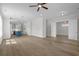 Open concept living room with hardwood floors, ceiling fan, and a view into the kitchen and dining area at 8148 Living Tide Dr., Myrtle Beach, SC 29572