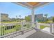 Charming porch with white railings offering views of a well-maintained front lawn and community at 8148 Living Tide Dr., Myrtle Beach, SC 29572