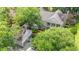 Aerial view of house with two-car garage surrounded by lush greenery and mature trees at 89 Cameron Ct., Pawleys Island, SC 29585