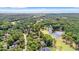 Aerial view of community with lush green golf course, pond, trees, and coastal landscape at 89 Cameron Ct., Pawleys Island, SC 29585