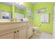 Bathroom featuring a white vanity with a mirror and vibrant green walls at 89 Cameron Ct., Pawleys Island, SC 29585