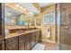 Bathroom featuring a double vanity, a large mirror, and a glass-enclosed shower at 89 Cameron Ct., Pawleys Island, SC 29585