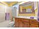 Well-lit bathroom with a wooden vanity and framed mirror at 89 Cameron Ct., Pawleys Island, SC 29585