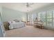 Bright bedroom features a daybed and large window with plantation shutters at 89 Cameron Ct., Pawleys Island, SC 29585