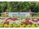 Entrance to Pawleys Plantation Golf and Country Club with colorful flowers and American flags at 89 Cameron Ct., Pawleys Island, SC 29585