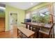Bright dining area with a wooden table, bench seating, and natural light from the windows at 89 Cameron Ct., Pawleys Island, SC 29585