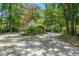 Exterior view with circular driveway, surrounded by lush greenery and mature trees at 89 Cameron Ct., Pawleys Island, SC 29585