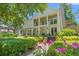 Charming home with lush landscaping, covered porch, and beautiful flowers along the walkway at 89 Cameron Ct., Pawleys Island, SC 29585