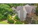 Aerial view of a neutral colored house with well-kept landscaping and mature trees at 89 Cameron Ct., Pawleys Island, SC 29585