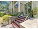 Inviting front entrance with stairs, black railing, and decor with potted plants at 89 Cameron Ct., Pawleys Island, SC 29585