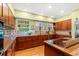 Charming kitchen featuring wood cabinets, stainless steel appliances, tile backsplash, and hardwood floors at 89 Cameron Ct., Pawleys Island, SC 29585