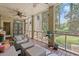 Cozy screened porch with comfortable seating and views of the surrounding greenery at 89 Cameron Ct., Pawleys Island, SC 29585