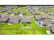 Aerial view of a neighborhood, featuring a home with a screened porch and expansive green lawn at 892 Harrison St., Myrtle Beach, SC 29579
