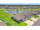 Beautiful aerial view of home with pond, landscaped lawn, white fence, and neighborhood at 892 Harrison St., Myrtle Beach, SC 29579