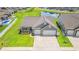 Aerial view of the home featuring a three car garage, manicured lawn and welcoming front porch at 892 Harrison St., Myrtle Beach, SC 29579